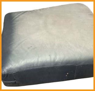 Cracked and dried leather cushion on a blue chair Cracked and dried leather cushion on a blue chair