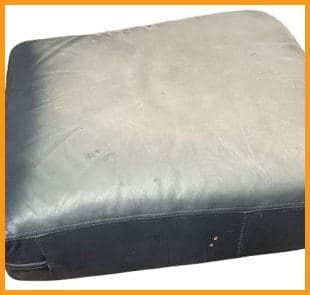 Sun-damaged and discolored leather on a blue club chair Sun-damaged and discolored leather on a blue club chair